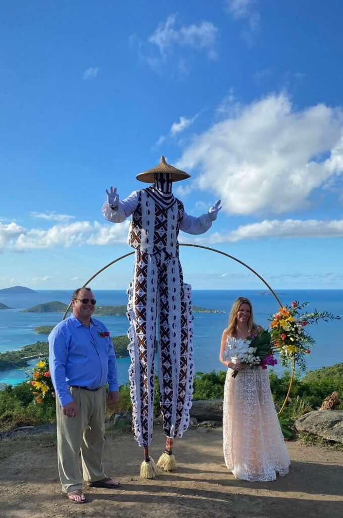 A wedding on the hill at The Windmill Bar, with a moko jumbie stilt dancer